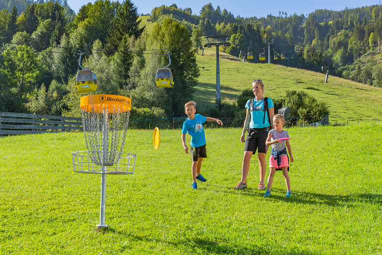 Mutter mit Kindern vor Disc-Golf Korb | © Hauser Kaibling@René Eduard Perhab