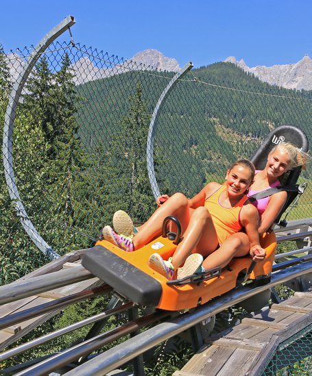 Teenagers in the summer toboggan run Alpin Coaster