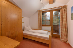 Bedroom 2 with single bed and balcony