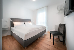 Second bedroom with cozy box spring bed