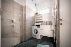 Second bathroom with rain shower & washing machine