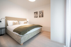 Second bedroom with cozy box spring bed