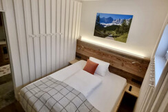 small bedroom with lights on 