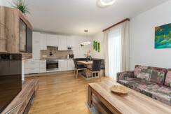 Top 2 - spacious living room with sofa and kitchen