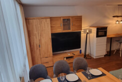 Living room with TV and dining area