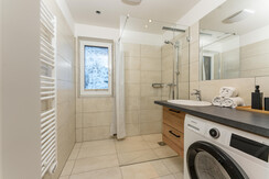 Bathroom with shower and washing machine